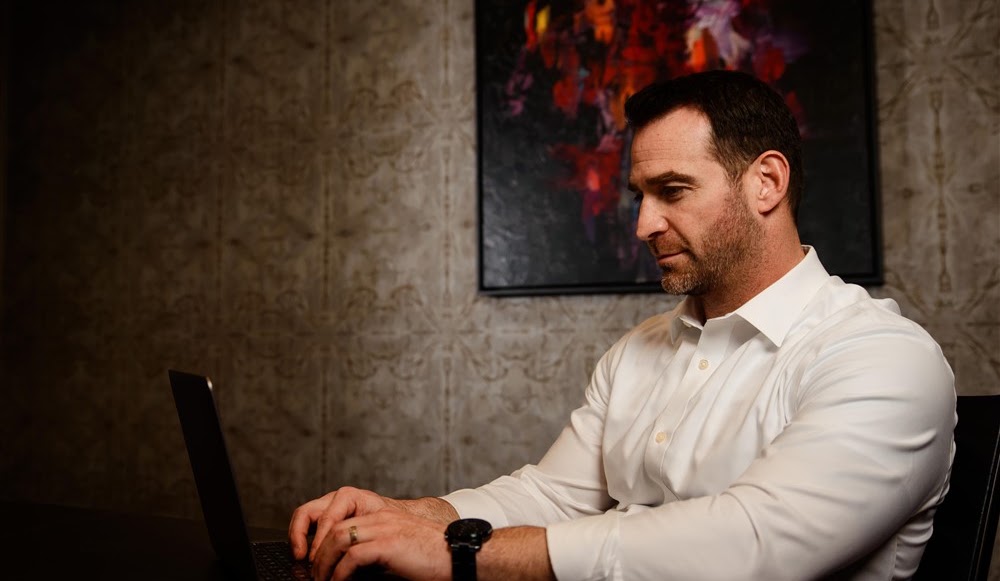 Marc Menkveld working at a laptop in his office
