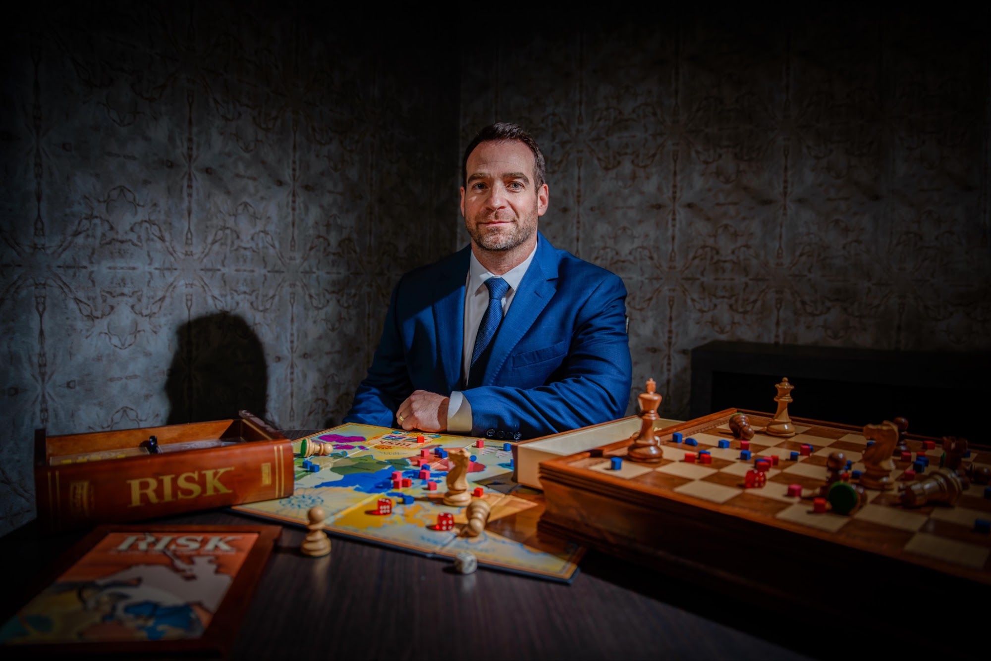Marc Menkveld seated at a table set with Risk and a chessboard
