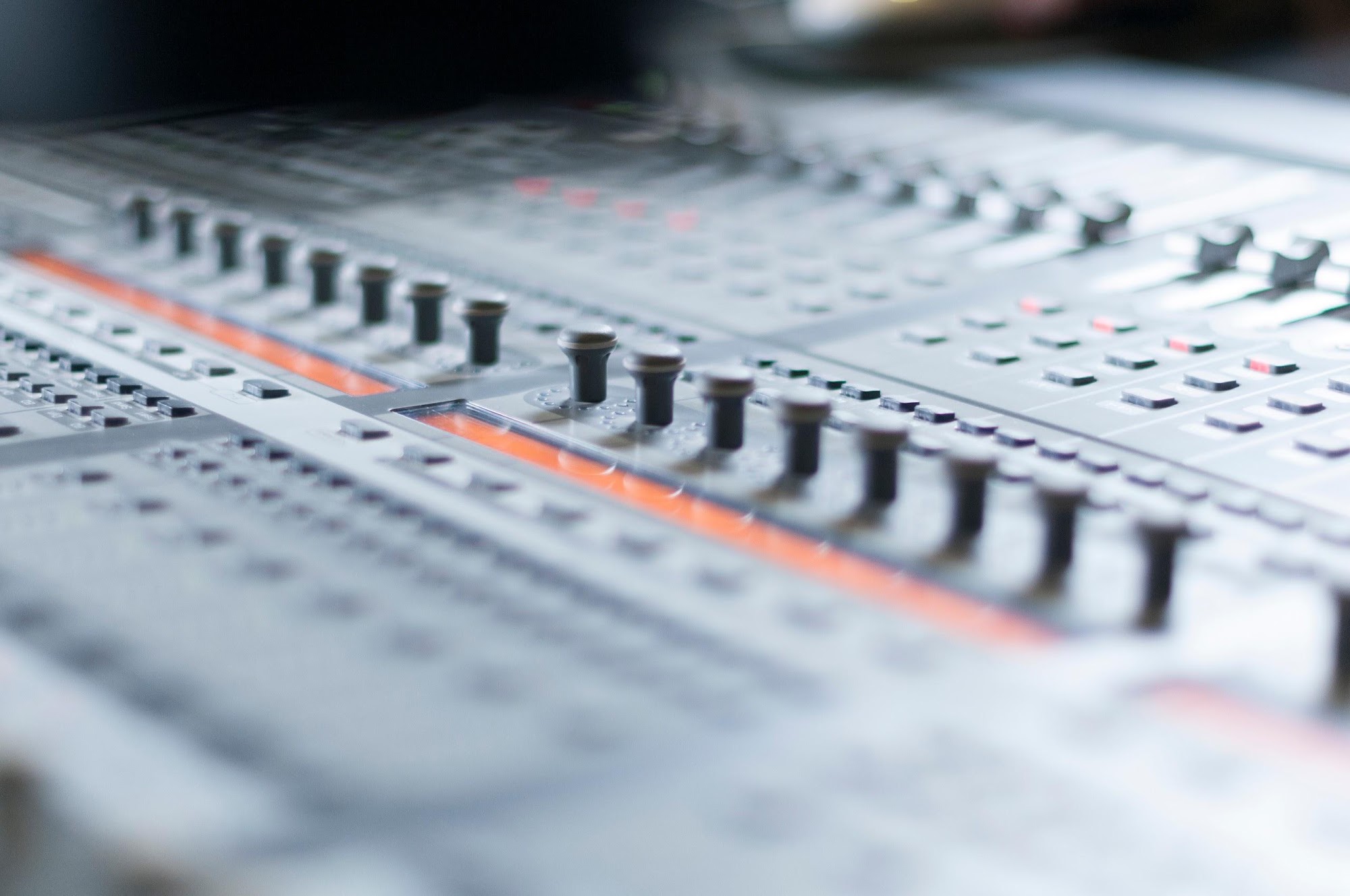 Close detail of a mixing console's faders